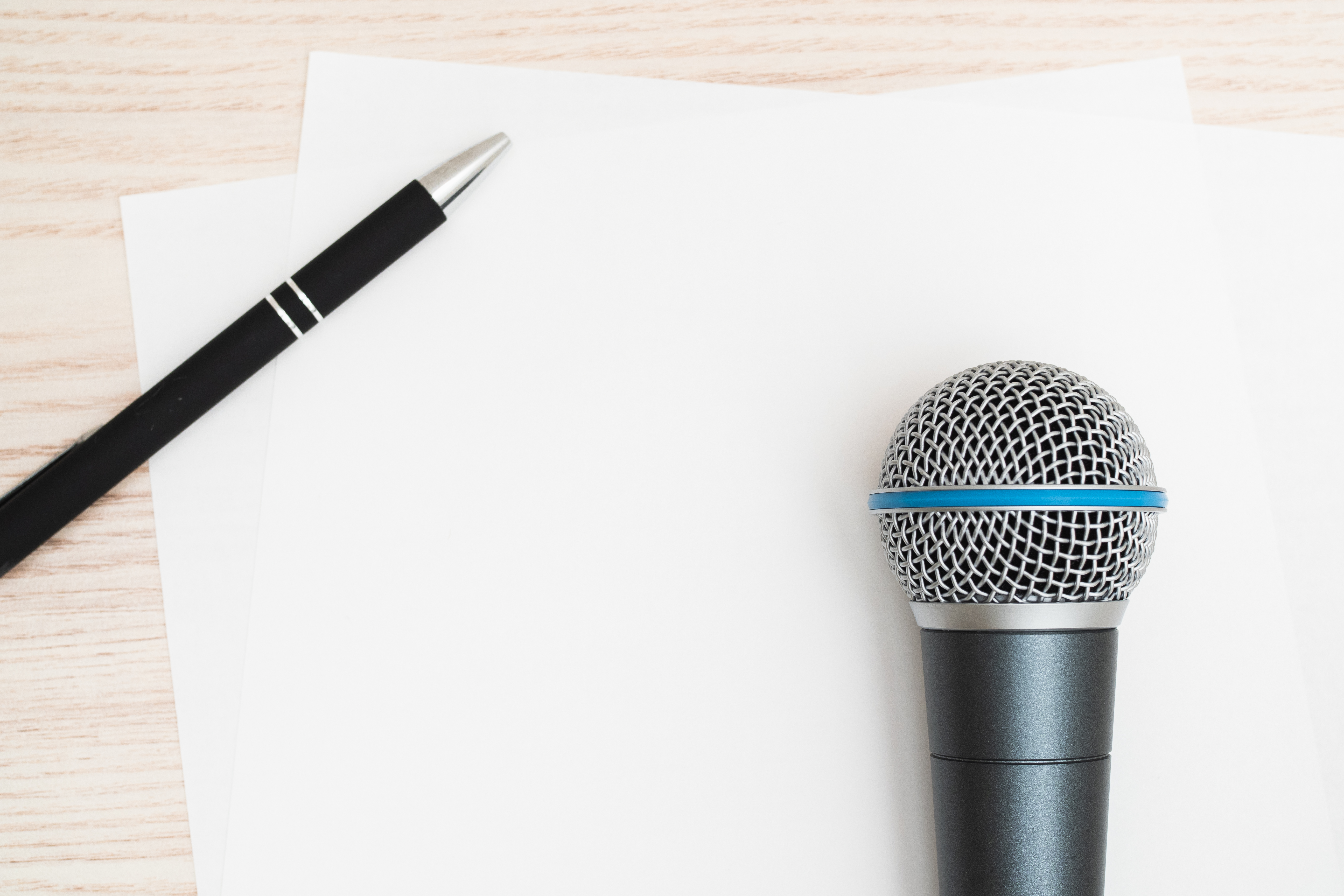Pen and microphone on a desk